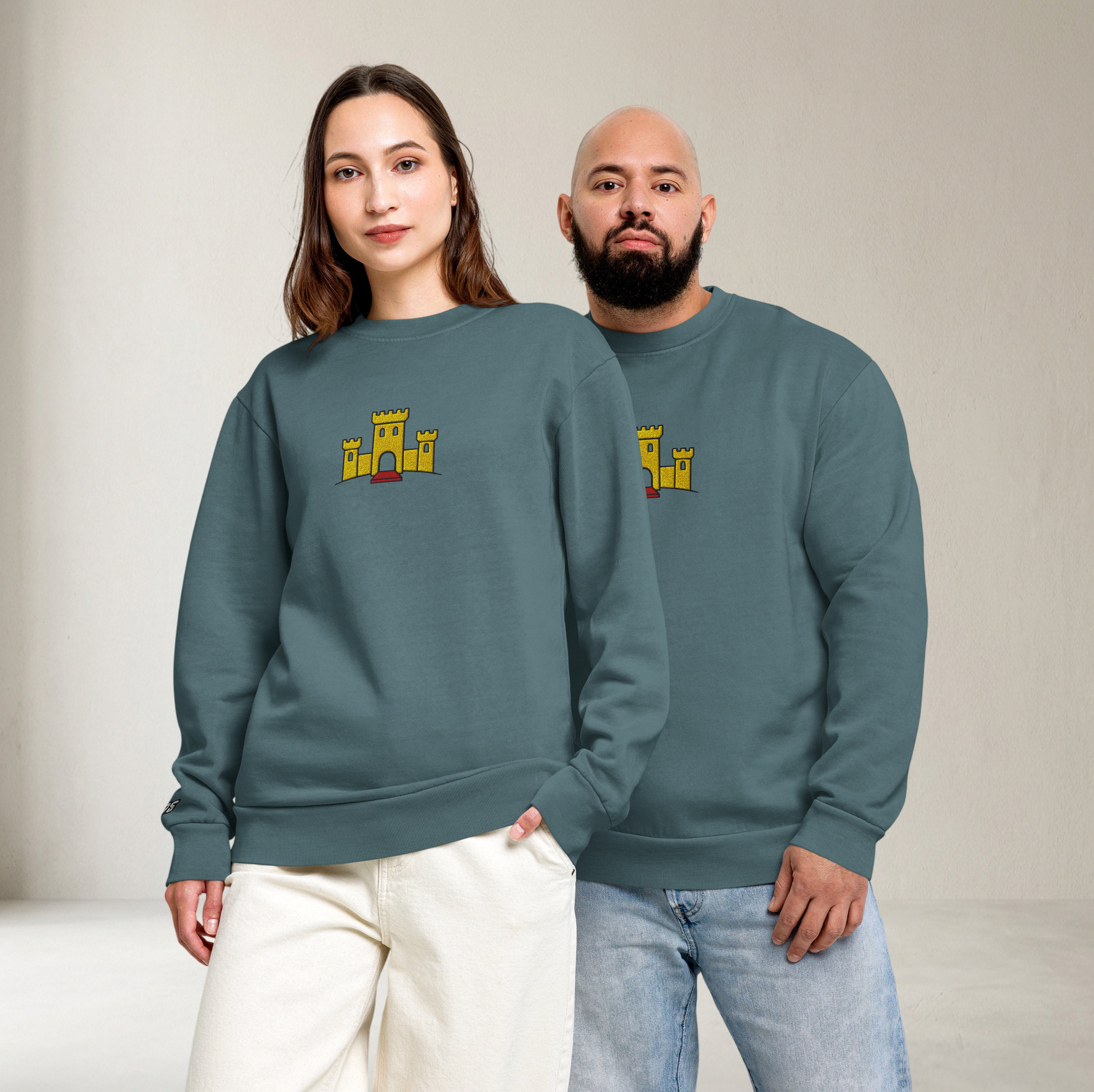 Fashionable male and female model couple wearing matching pebble blue tri-blend fleece sweatshirt featuring a classic fan-made OG yellow castle design embroidered across the front and setshirt number 375 on the sleeve.