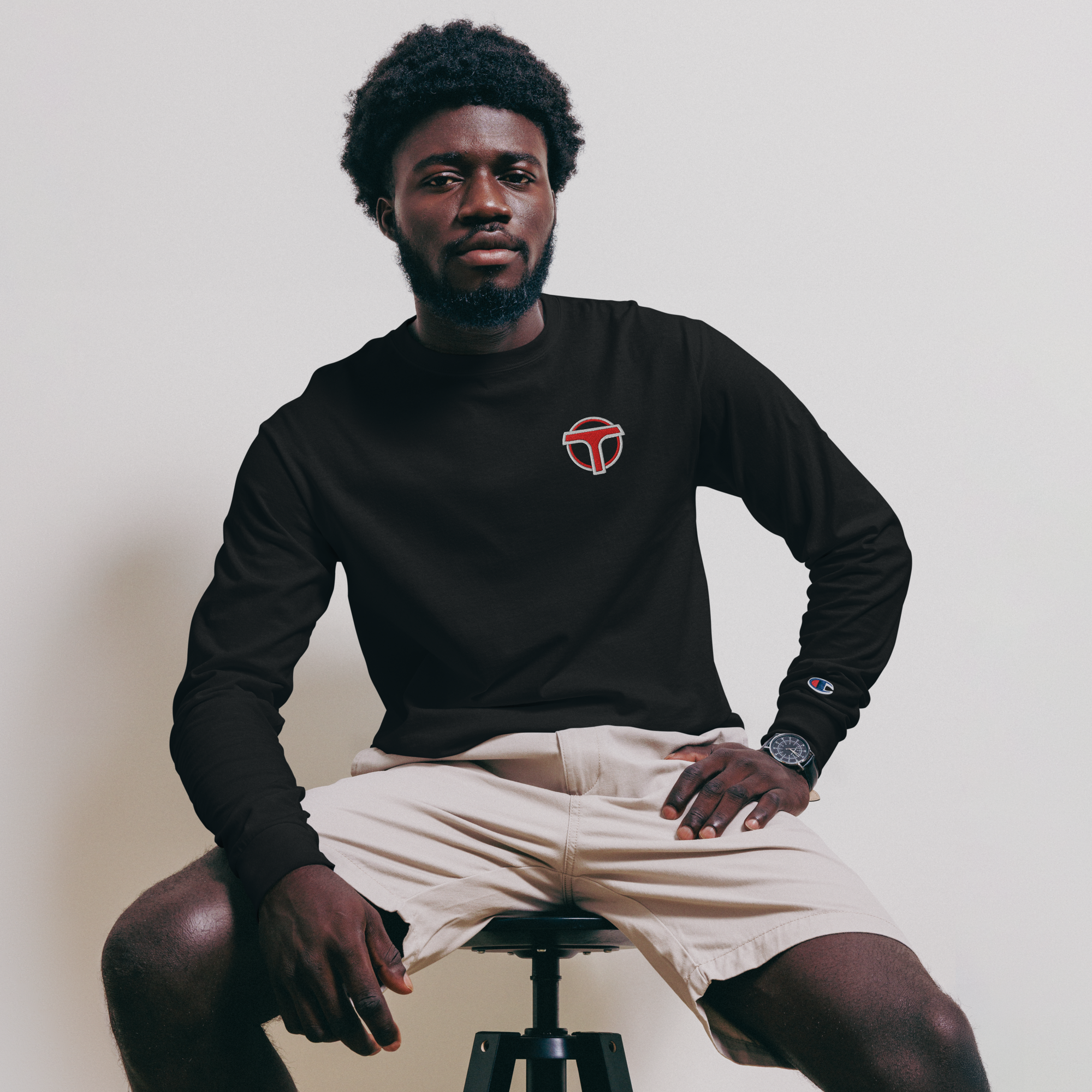 Black lightweight, 100% cotton luxury Champion© shirt featuring airport shuttle emblem embroidered in the top right corner. Item is a BRKDrip Builder's Collection luxury longsleeve shirt with a classic town building block aesthetic.