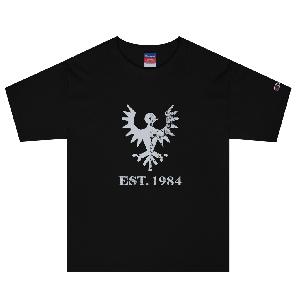 Black heavyweight, 100% cotton luxury Champion© t-shirt featuring aged falcon emblem and text "EST. 1984" indicating the year the faction was first introduced to the brick universe. Item is a BRKDrip Heritage Collection luxury shirt with a vintage castle building block aesthetic.