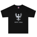 Black heavyweight, 100% cotton luxury Champion© t-shirt featuring aged falcon emblem and text "EST. 1984" indicating the year the faction was first introduced to the brick universe. Item is a BRKDrip Heritage Collection luxury shirt with a vintage castle building block aesthetic.