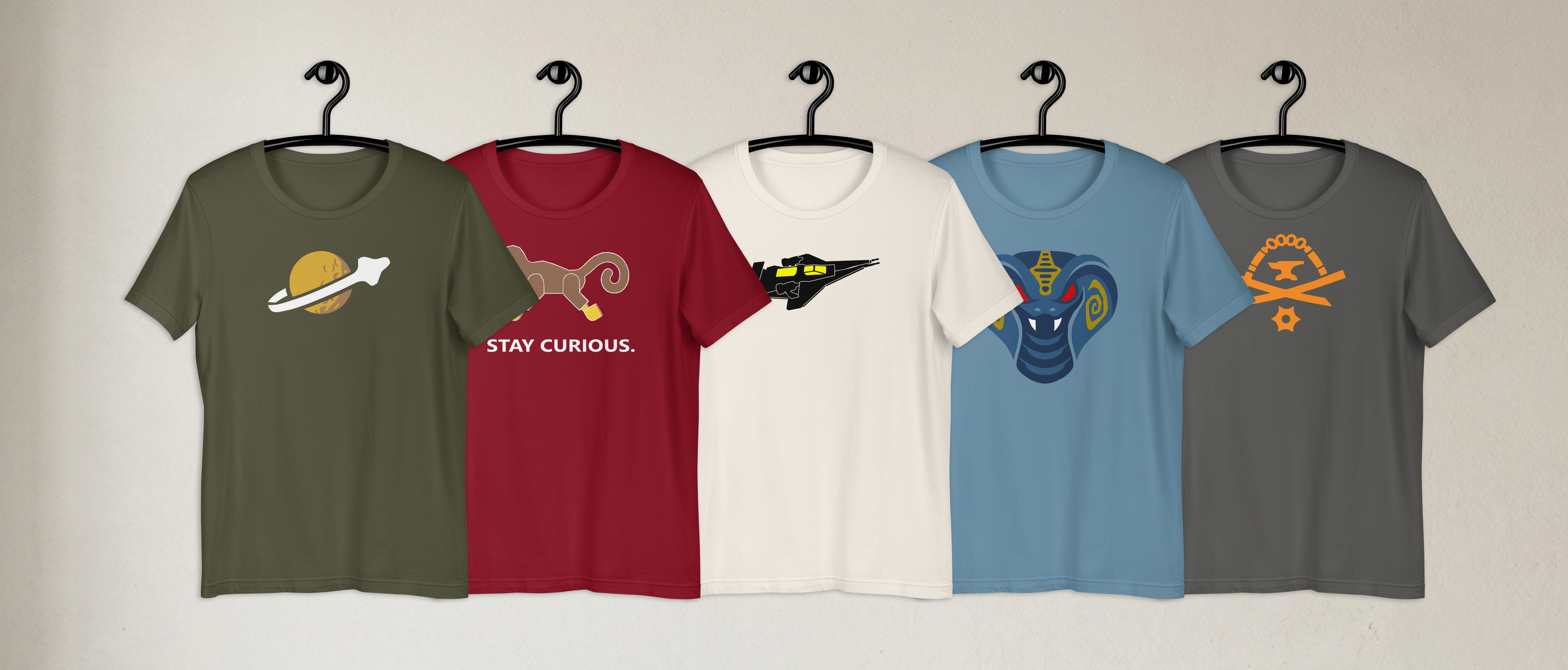 Five BRKDrip AFOL Essentials 100% airlume cotton t-shirts, each featuring fan-made vector art and brick-inspired designs. The shirts are in a modern color palette including olive, maroon, natural, steel blue, charcoal gray and have a mix of  vintage space, castle, town, and elemental brick master building blocks aesthetics.