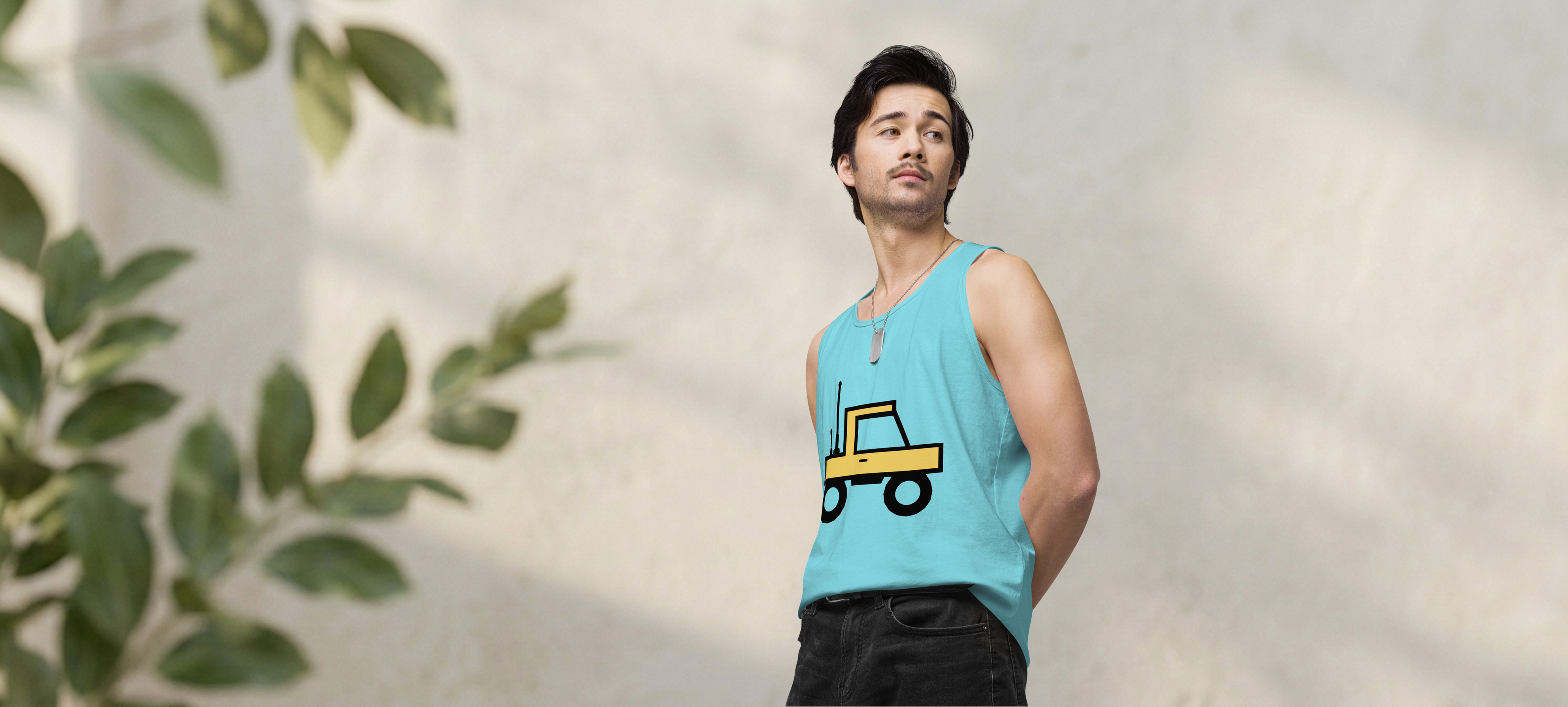 Fashionable male model wearing pacific blue 100% airlume cotton t-shirt featuring classic fan-made orange/yellow brick trucker with dual antenna design. Item is a BRKDrip premium summer wear tank top with a classic town building blocks aesthetic.