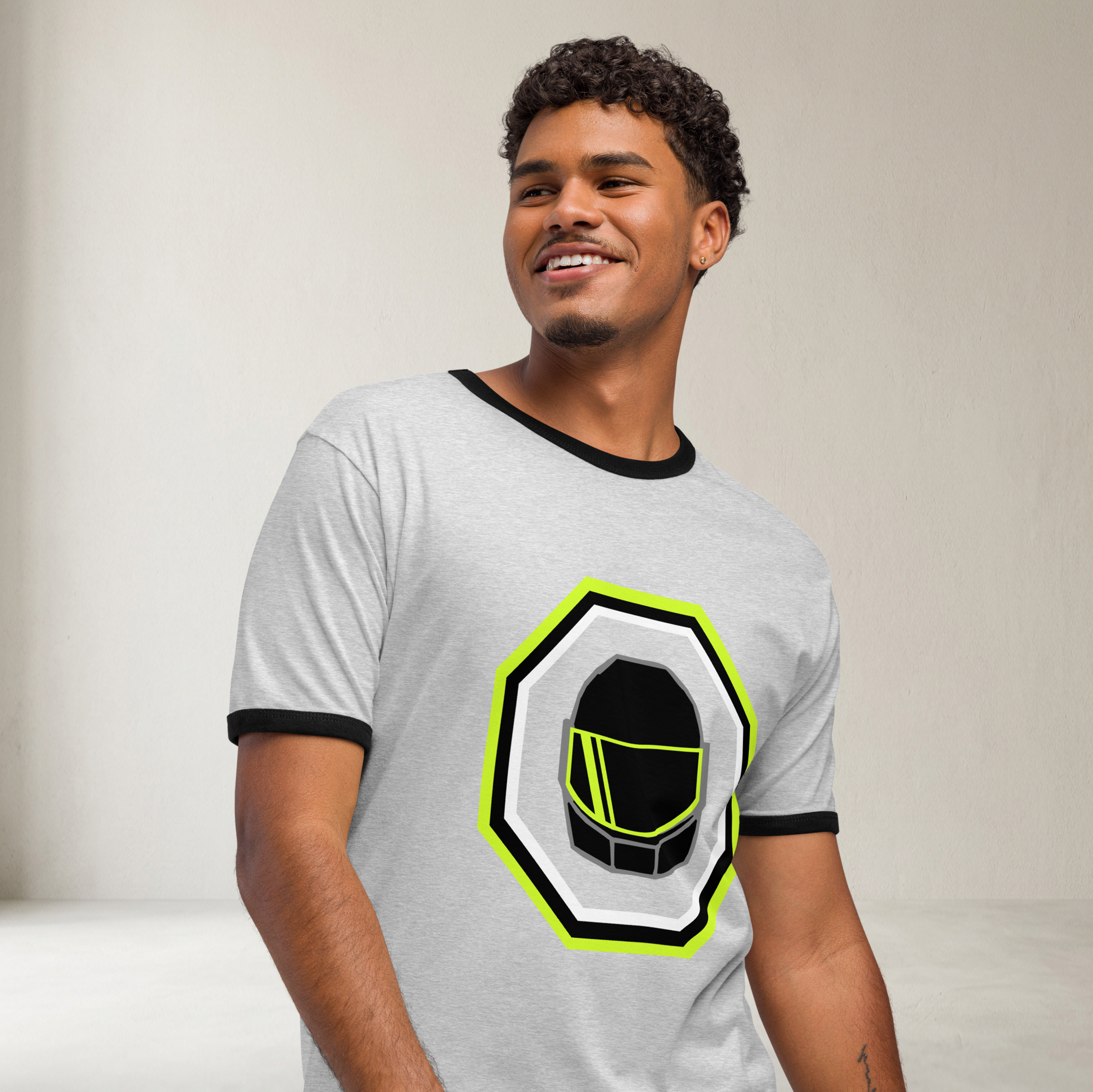 Fashionable male model wearing a grey airlume cotton t-shirt featuring classic fan-made galactic spies helmet design with high-contrast black ribbing on the sleeve and neck. Item is a BRKDrip Retro Collection t-shirt with a vintage space building blocks aesthetic.