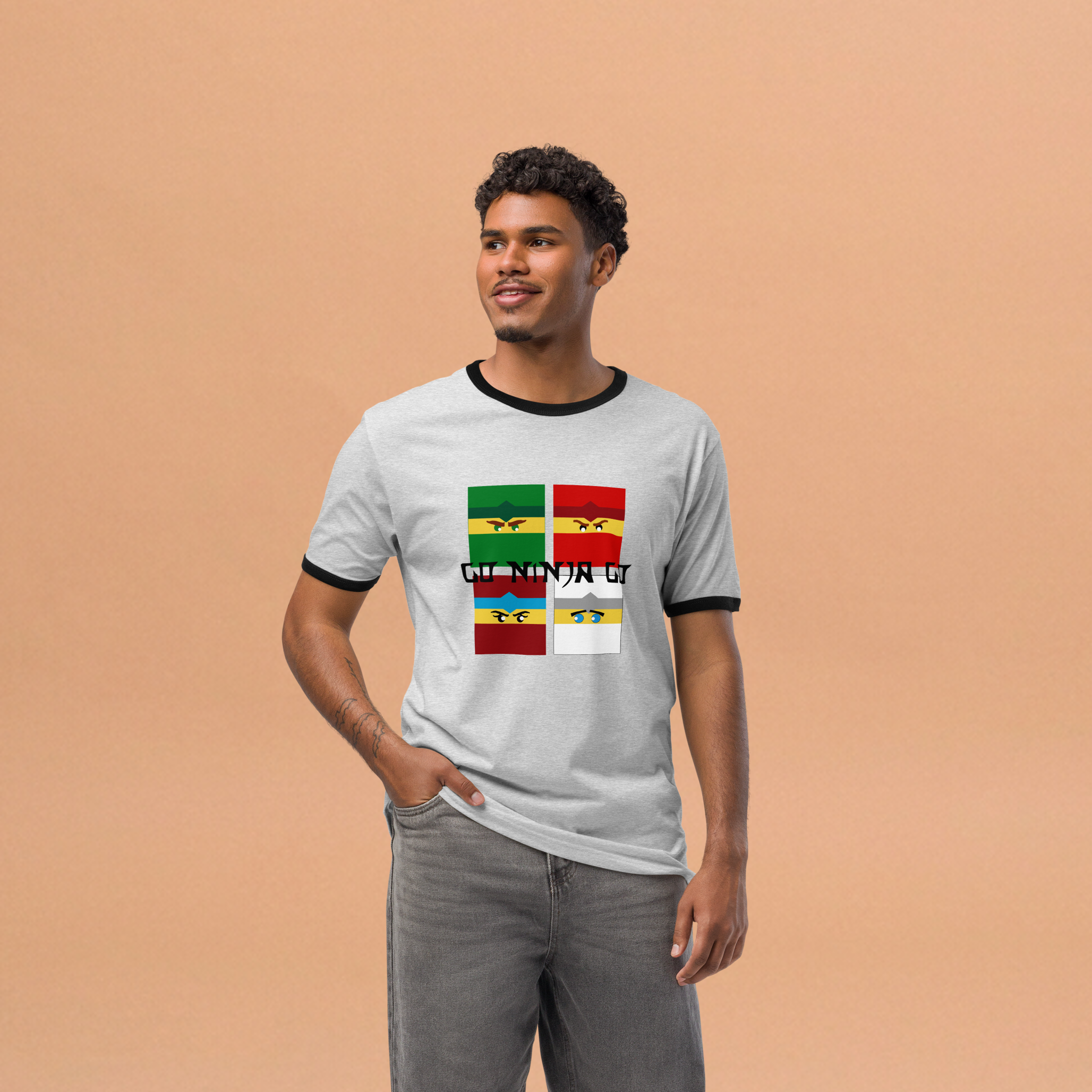Fashionable male model wearing grey airlume cotton t-shirt featuring four boxy ninja heads and parody crossover AFOL saying design with high-contrast black ribbing on the sleeve and neck. Item is a BRKDrip Retro Collection t-shirt with a modern elemental brick master aesthetic.