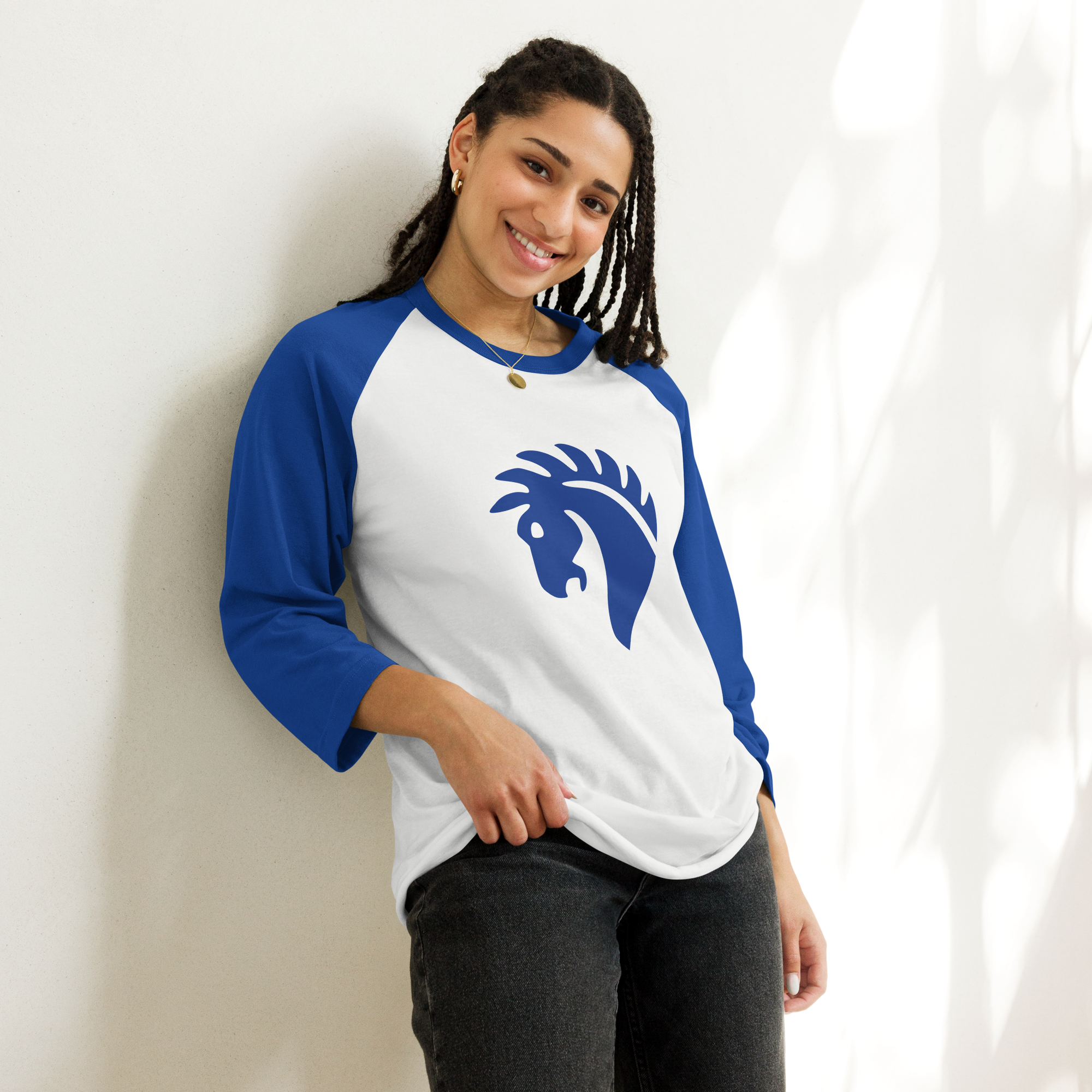 Fashionable female model wearing white 100% cotton shirt with blue 3/4 length sleeves featuring classic fan-made horse knights emblem in matching blue. Item is a BRKDrip retro collection baseball tee with a vintage castle building blocks aesthetic.