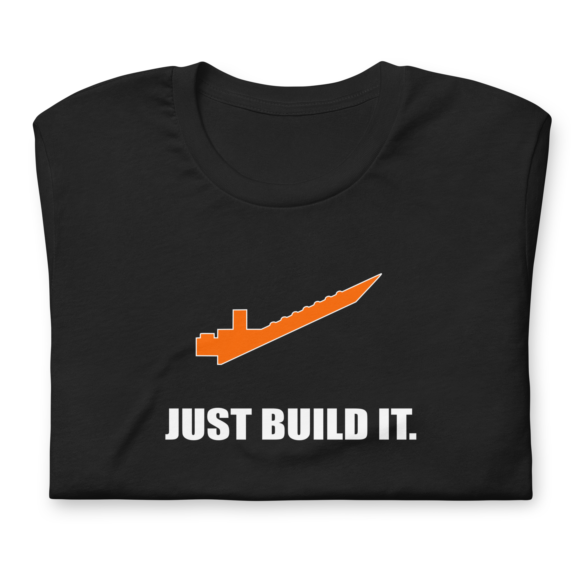Folded vintage black 100% airlume cotton t-shirt featuring orange brick separator and parody AFOL saying: "Just Build It". Item is a BRKDrip AFOL essentials shirt with a modern brick-inspired aesthetic.