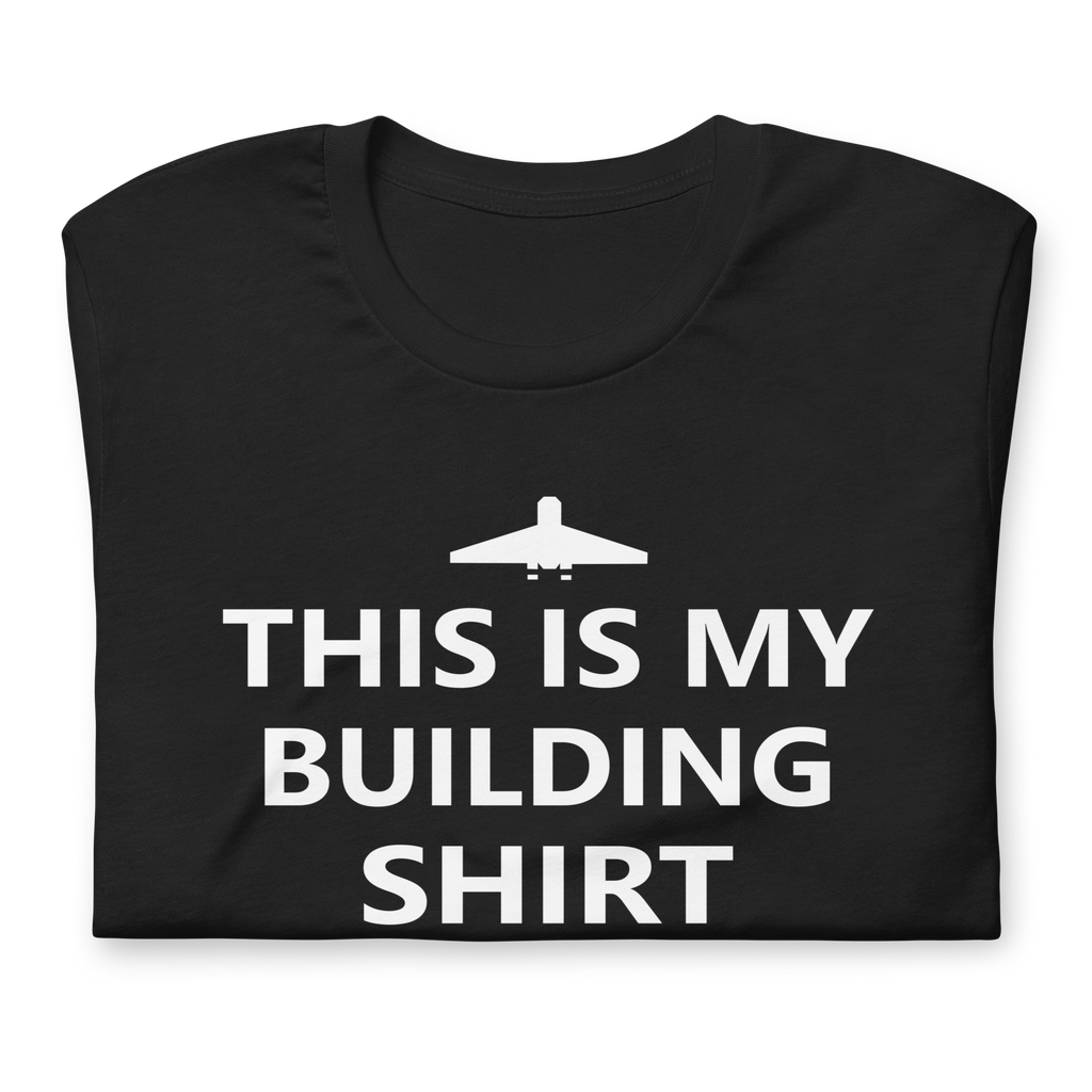 Folded vintage black 100% airlume cotton t-shirt featuring brick city airport logo and parody AFOL saying: "This is my Building Shirt". Item is a BRKDrip AFOL essentials shirt with a modern brick-inspired aesthetic.