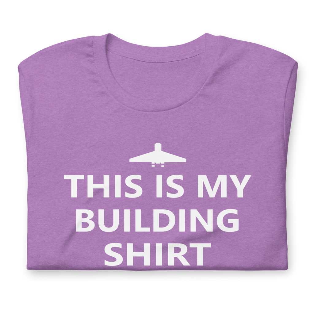 Folded heather purple airlume cotton t-shirt featuring brick city airport logo and parody AFOL saying: "This is my Building Shirt". Item is a BRKDrip AFOL essentials shirt with a modern brick-inspired aesthetic.