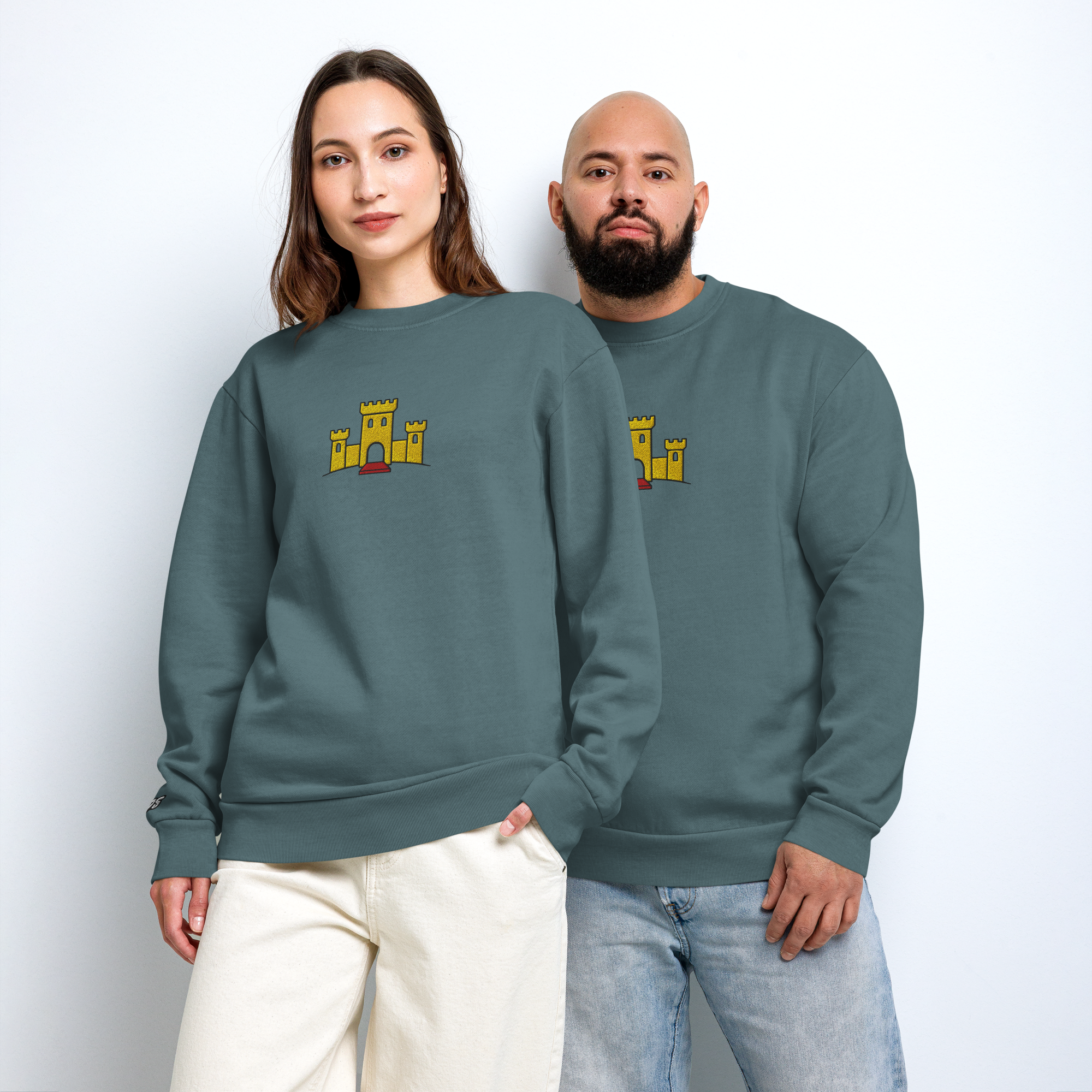 Fashionable male and female model couple wearing matching pebble blue tri-blend fleece sweatshirt featuring a classic fan-made OG yellow castle design embroidered across the front and setshirt number 375 on the sleeve. Item is a BRKDrip Limited Edition Cozy Wear Sweatshirt with a vintage castle building blocks aesthetic.