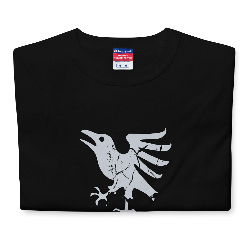 Folded black heavyweight, 100% cotton luxury Champion© t-shirt featuring aged raven emblem and text "EST. 2020" indicating the year the faction was first introduced to the brick universe. Item is a BRKDrip Heritage Collection luxury shirt with a vintage castle building block aesthetic.