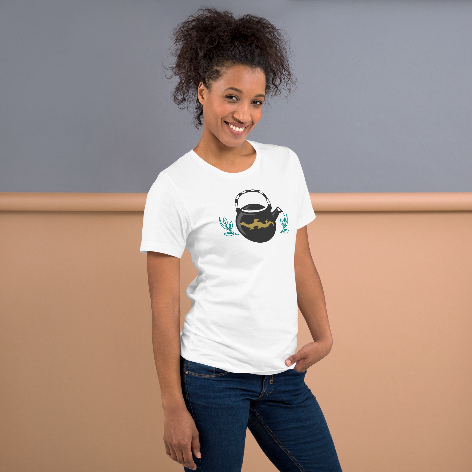 Fashionable female model against brightly lit orange background wearing a white 100% airlume cotton t-shirt featuring a classic fan-made, stylized teapot with brick ninja dragon design. Item is a BRKDrip AFOL essentials shirt with a modern elemental brick master aesthetic. 