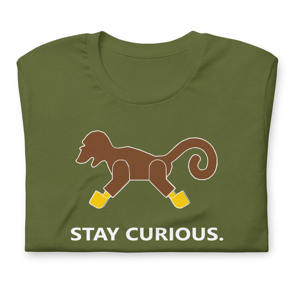 Folded olive green 100% airlume cotton t-shirt featuring classic fan-made brick monkey design with parody AFOL slogan "Stay Curious". Item is a BRKDrip AFOL essentials shirt with a vintage pirate building blocks aesthetic.