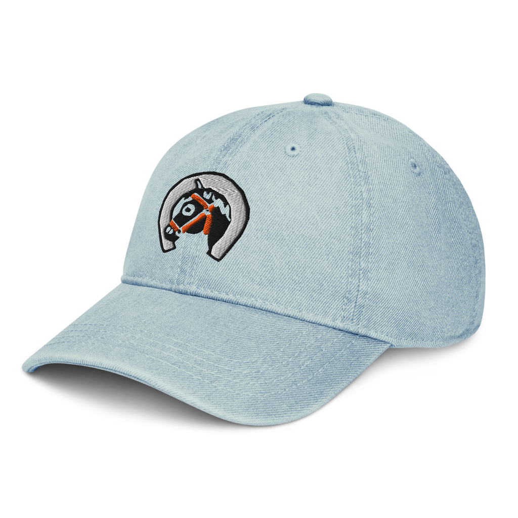 Side profile of denim light blue cotton baseball cap hat featuring embroidered sunset stables ranch design. Item is a BRKDrip AFOL Headgear Dad Hat with a modern town building blocks aesthetic.
