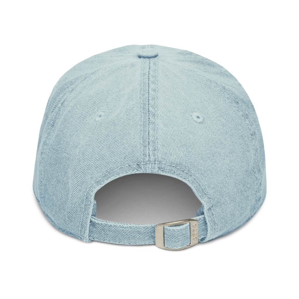 Back view of metal buckle and adjustable strap on a denim light blue cotton baseball cap hat featuring embroidered sunset stables ranch design. Item is a BRKDrip AFOL Headgear Dad Hat with a modern town building blocks aesthetic.